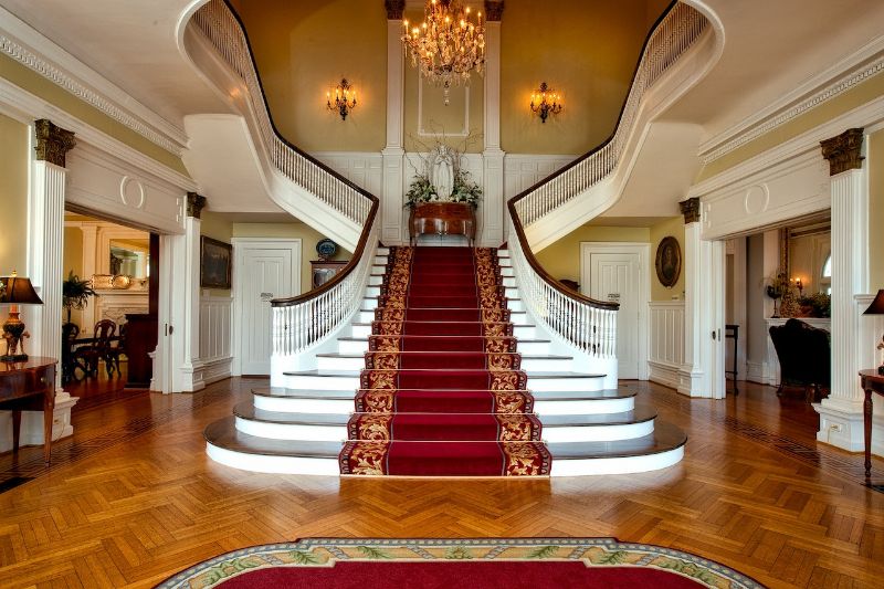 red and brown floral bifurcated staircase with carpet
