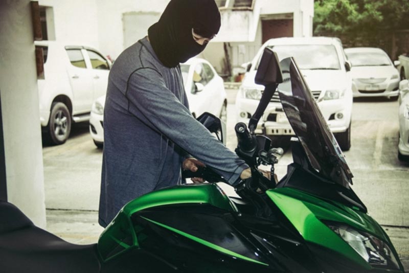 thief stealing green motorcycle