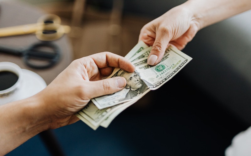 two people exchanging payment for goods