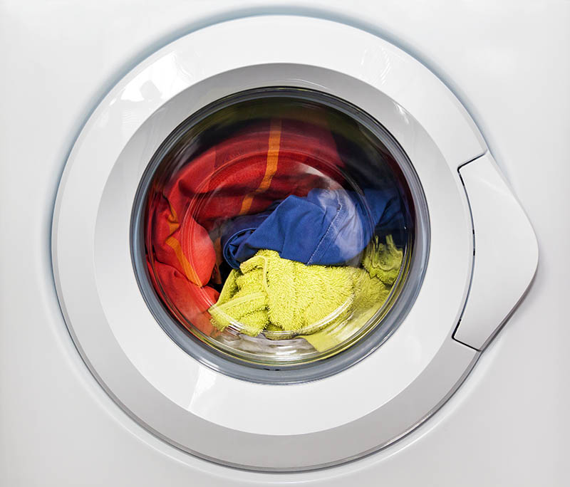 washing machine spinning with dirty clothes inside