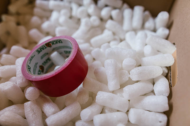 white packing peanut and a red tape