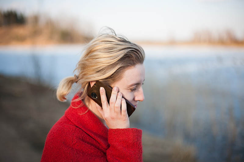 woman calling someone through mobile phone