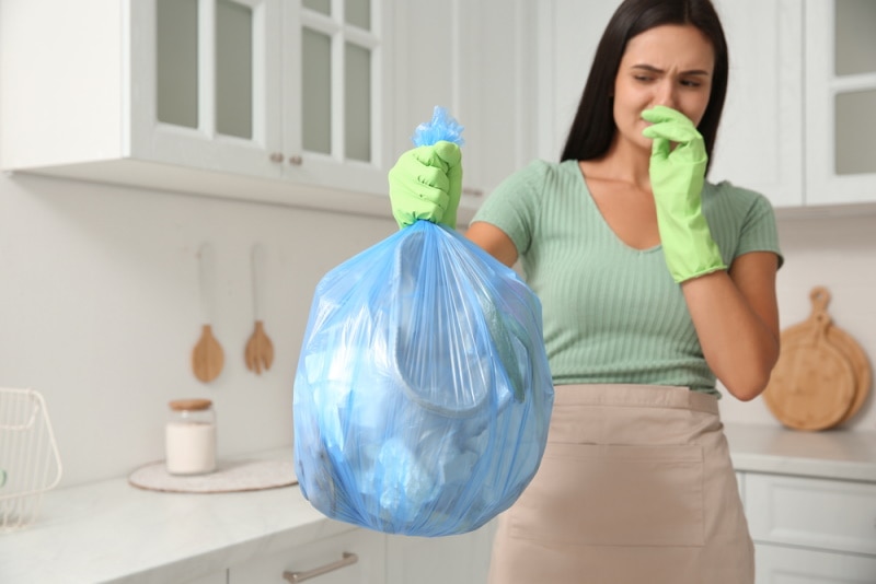 woman holding garbage bag