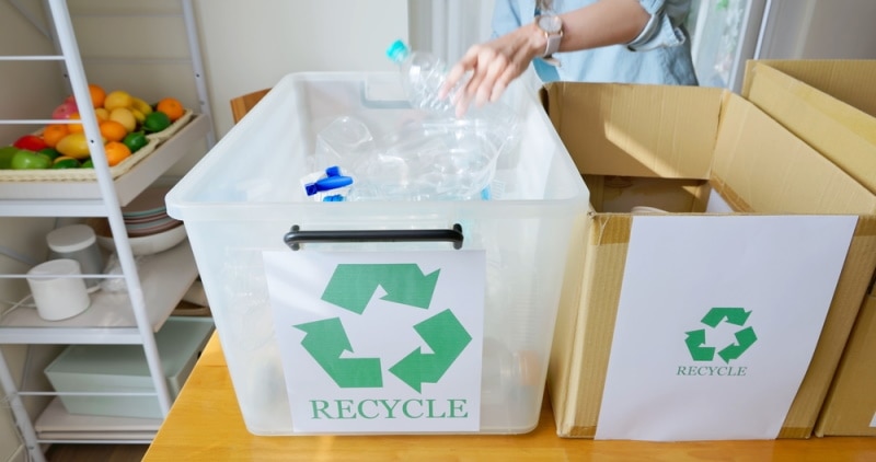 woman recycling plastic bottles