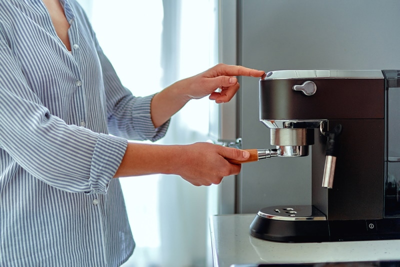 woman using coffee maker