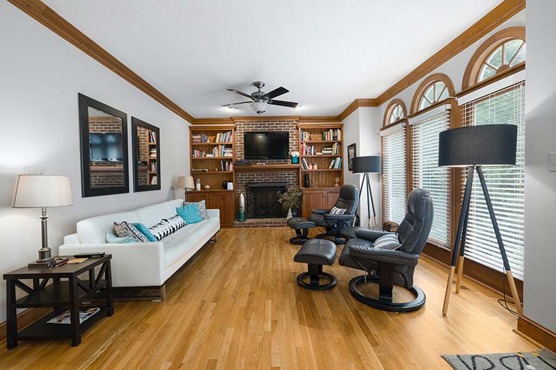 A Living Room With a White Sofa and arched windows