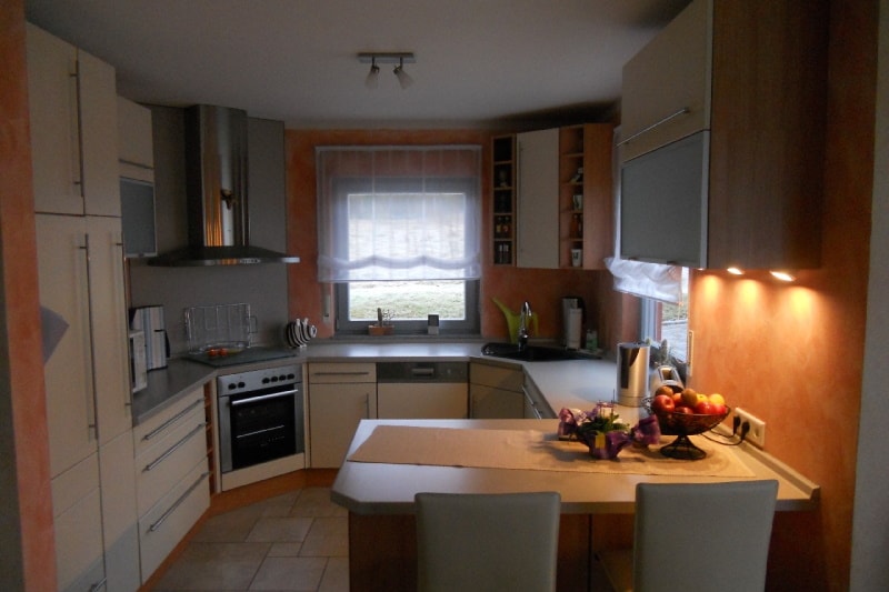 A compact kitchen with orange walls
