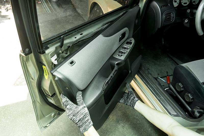Auto mechanic remove car front door trim