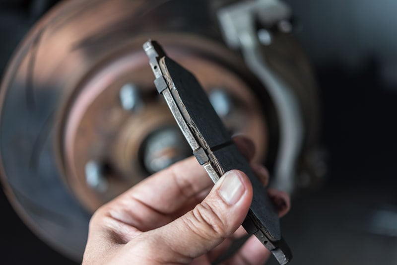 Car mechanic or serviceman checking a disc brake