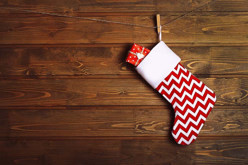 Christmas stocking hanging against wooden wall