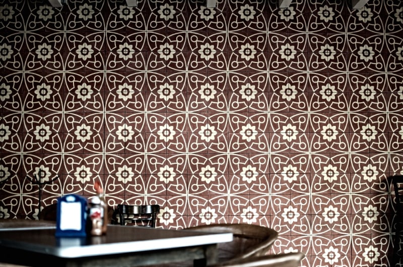 Dining room with brown and white tile wall