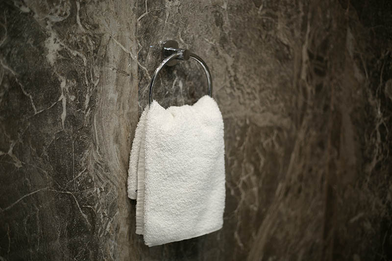 Face towel isolated hanging on the round circle metal hanger in the restroom