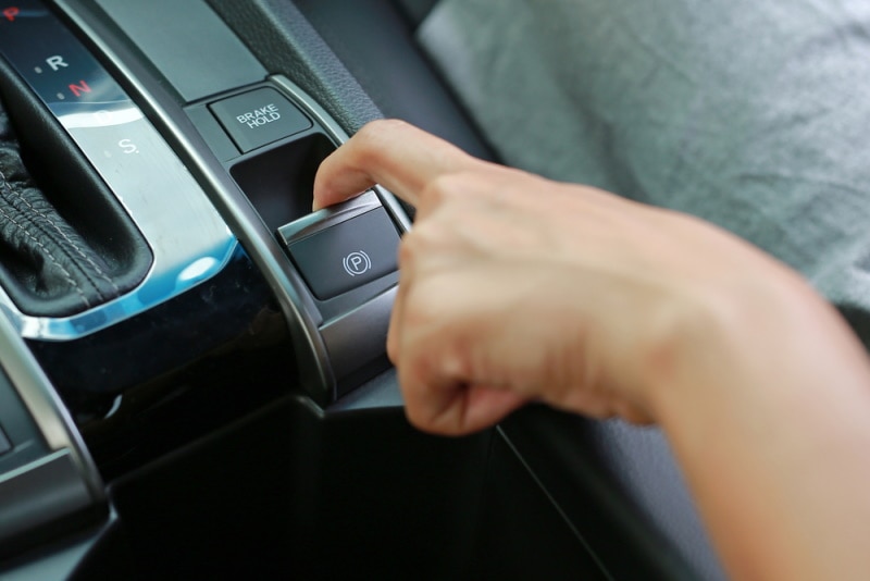 Finger pulling the electronic emergency brake