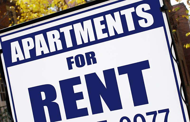 For rent sign in front of apartment building