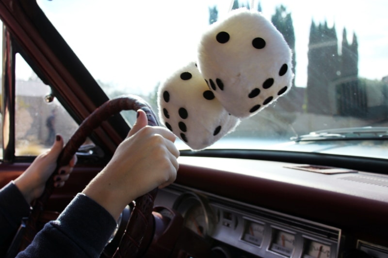Giant die stuffed toys hanging from rearview mirror