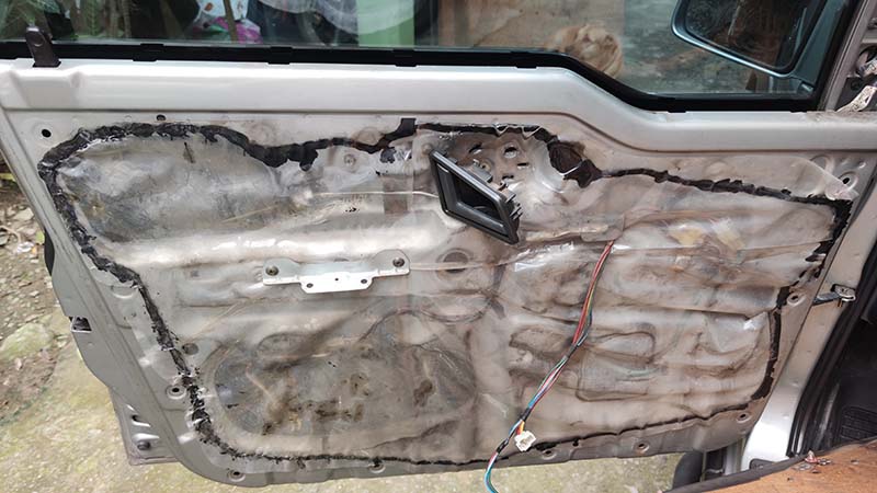 Inside of a car door that has been removed for door latch repair
