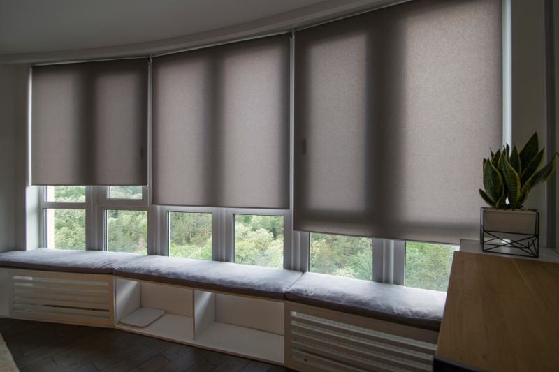 Motorized roller shades blinds in the window