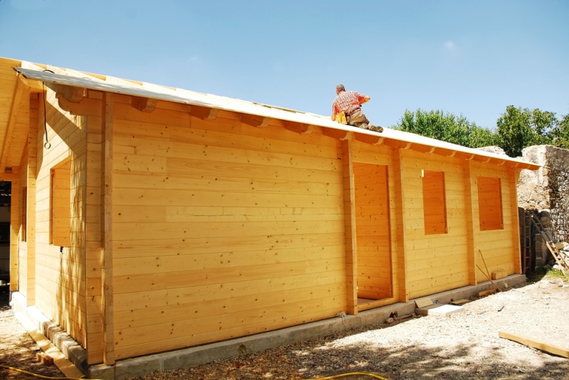 Pre-fab bungalow being built by worker
