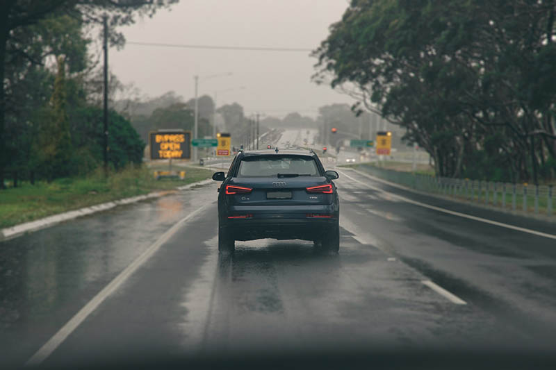 SUV on the road while raining