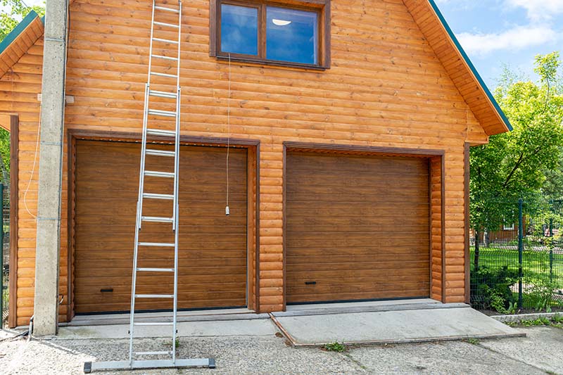 Tall extended aluminium professional ladder equipment on building facade