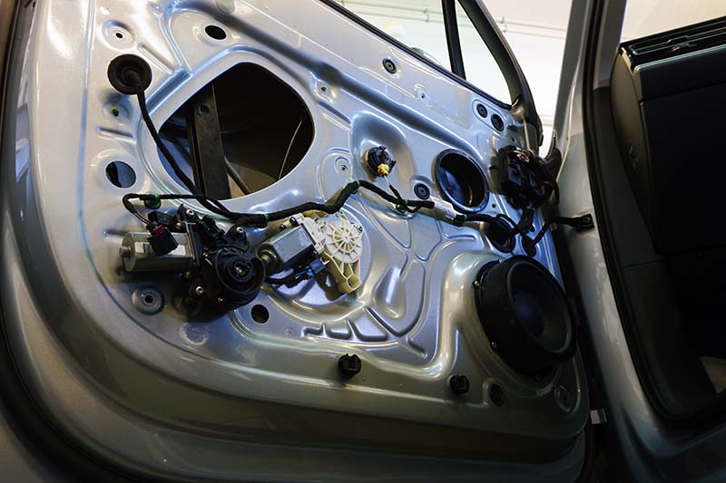 The inner lining has been removed from the door of a modern car
