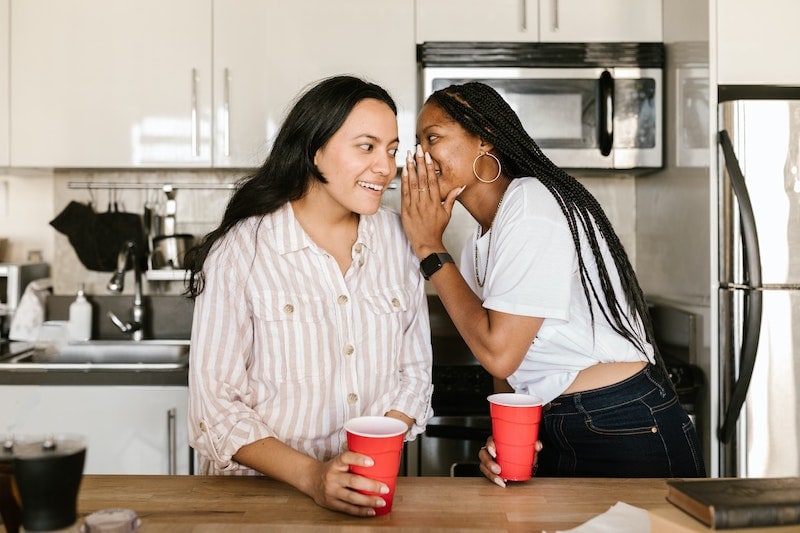 Two woman whispering