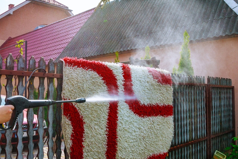 Washing a rug with a pressure washer