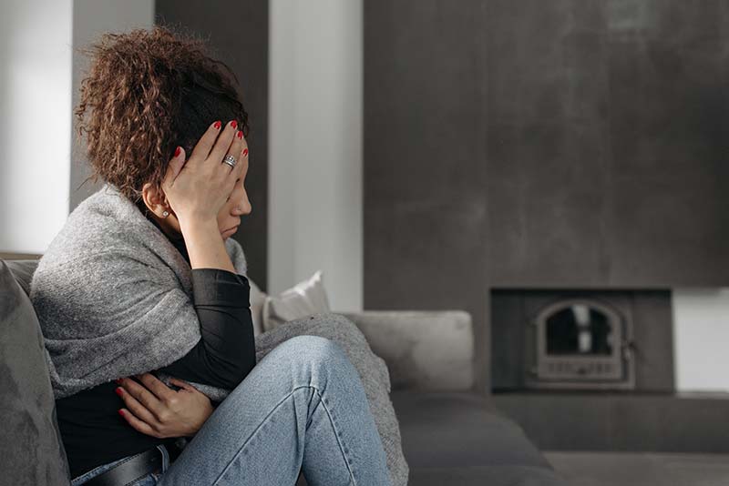 Woman at home being uncomfortable
