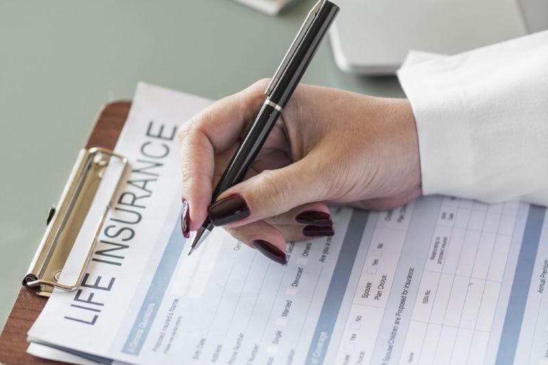 Woman filling up insurance form