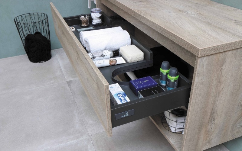 bathroom sink with open organized drawers