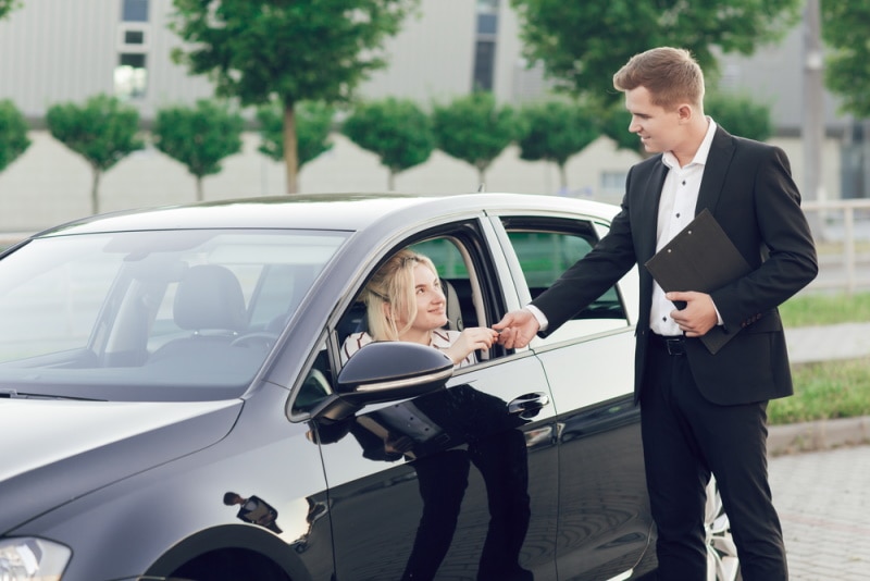 car salesman talking to costumer