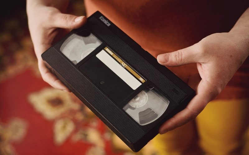 close up of VHS tape in a person's hands