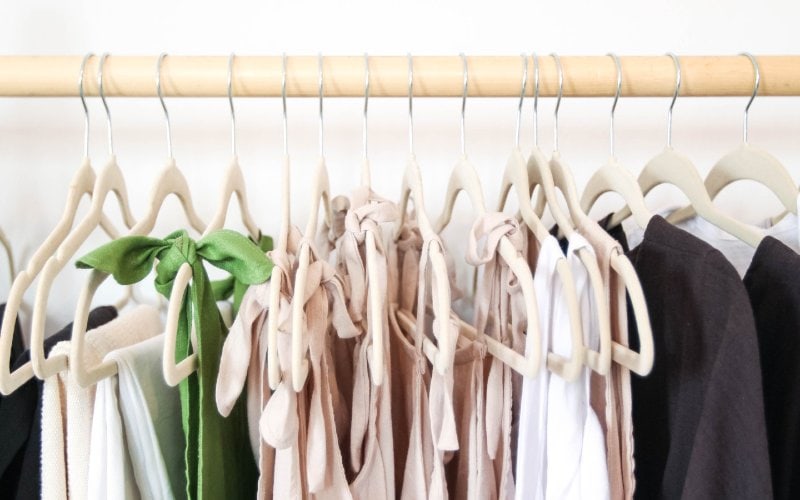 clothes on velvet hangers on a rack