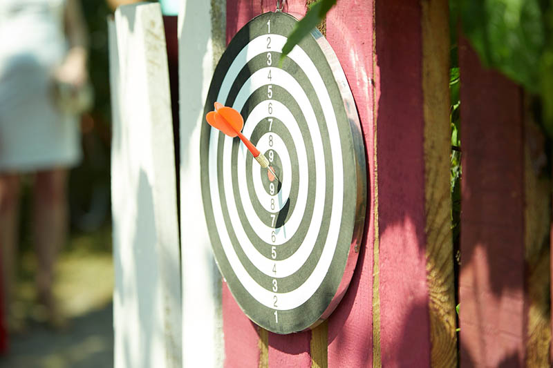 dartboard handing on a wooden wall