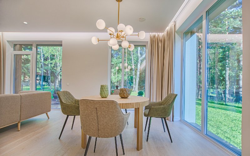dining and living room area with big windows