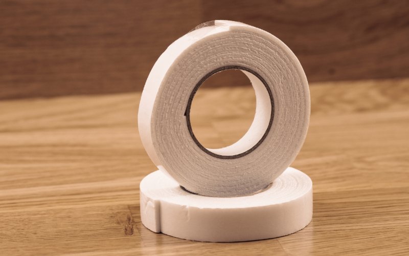 double sided mounting tape on wood surface