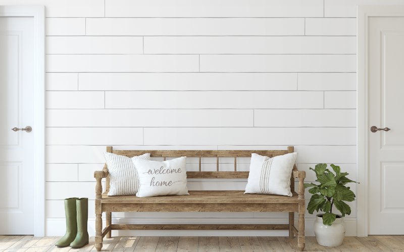farmhouse entryway with a white shiplap wall