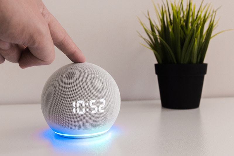 finger touching the Amazon echo dot 4