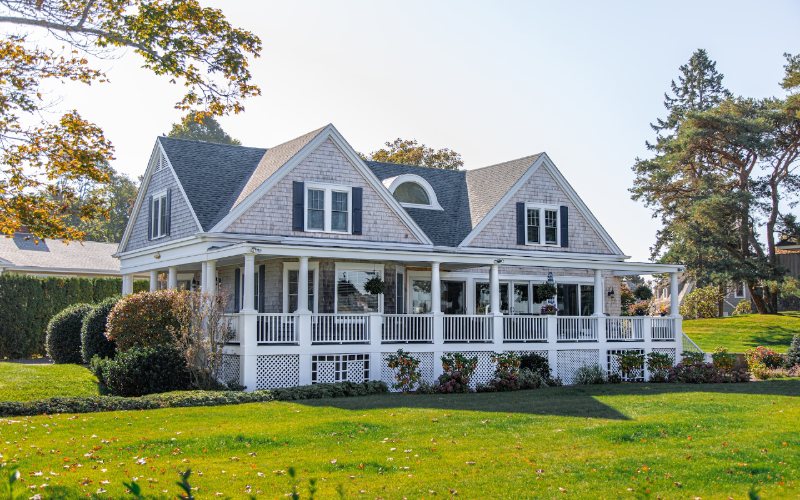 gray and white house with a big grass yard