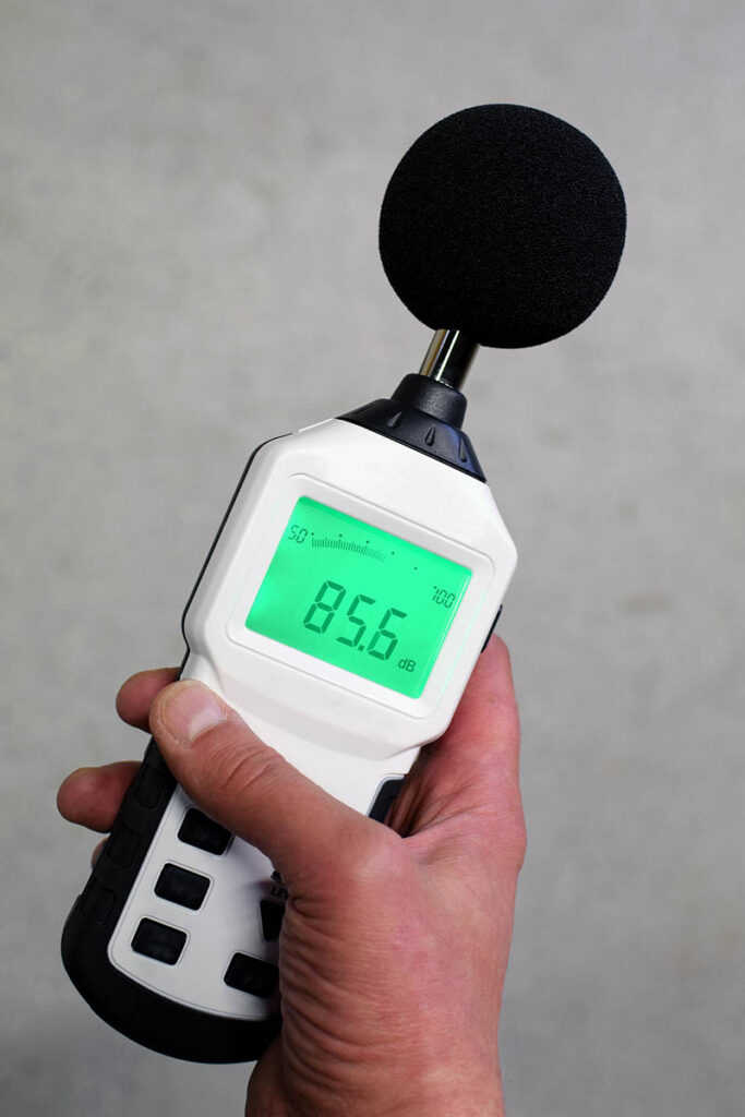 Hand holding sound level meter