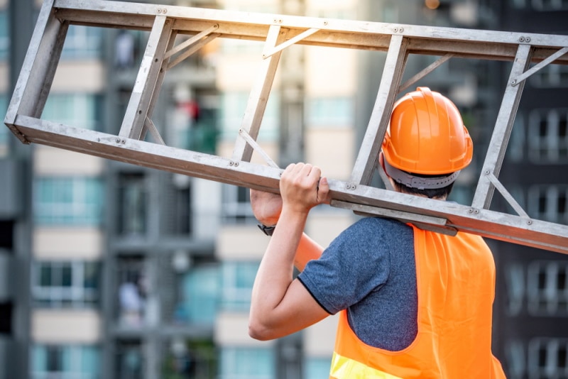 man carrying a ladder