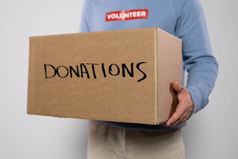 man carrying donation box