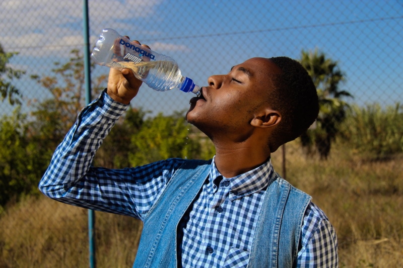 man drinking bottle water