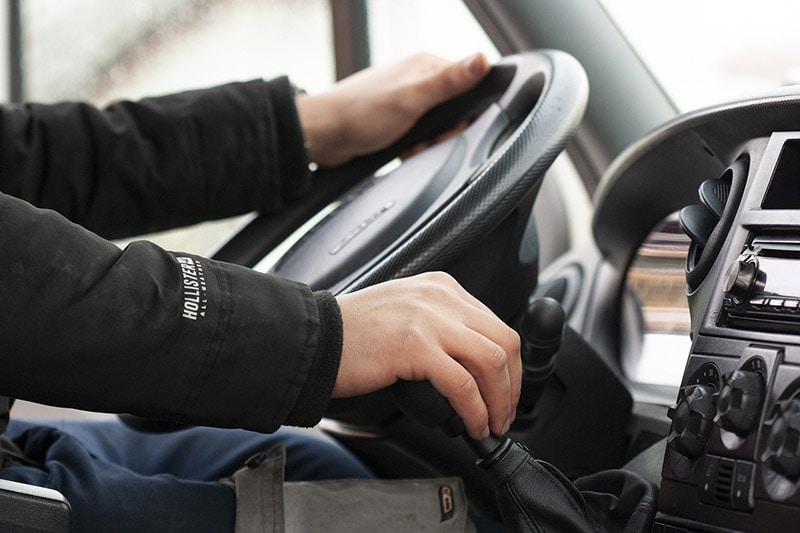 man driving a manual transmission car