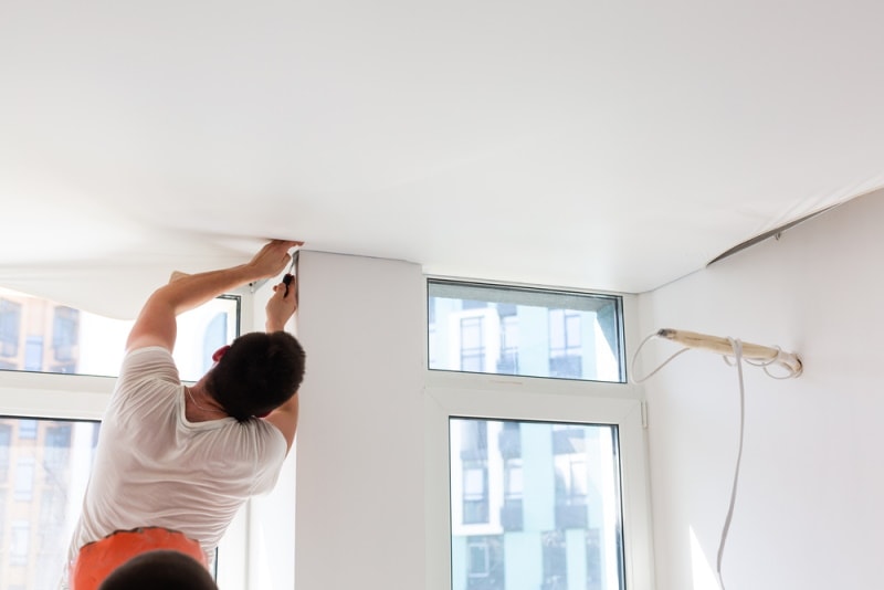 man fixing ceiling