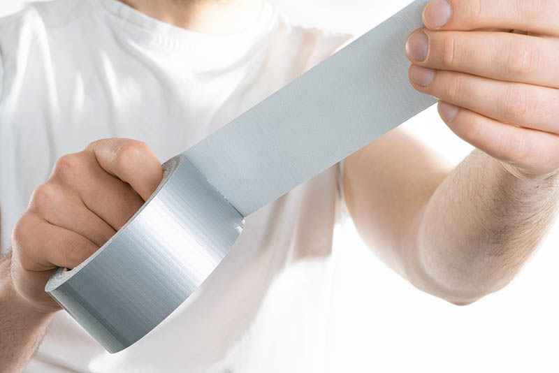 man holding adhesive duct tape
