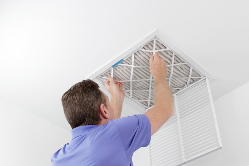 man removing air filter