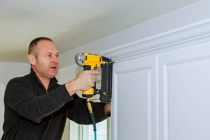 man using brad nailer