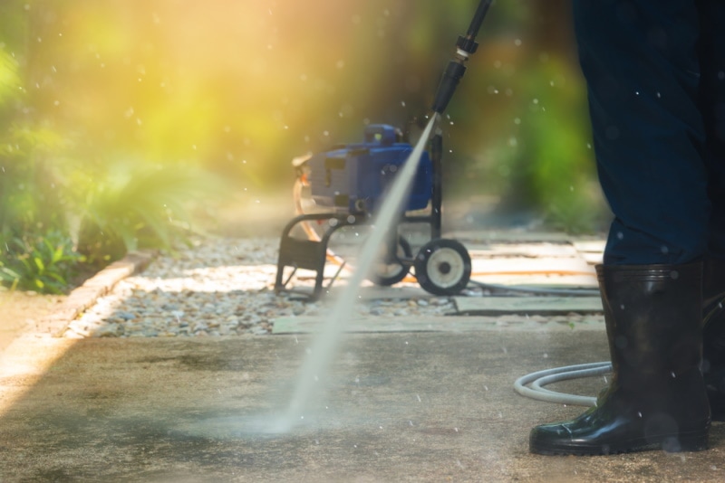 man using pressure washer