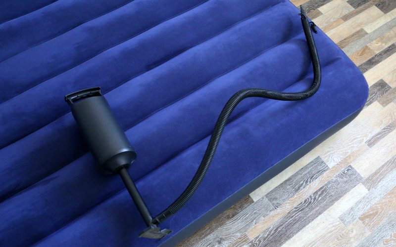 manual air pump on top of inflatable bed mattress